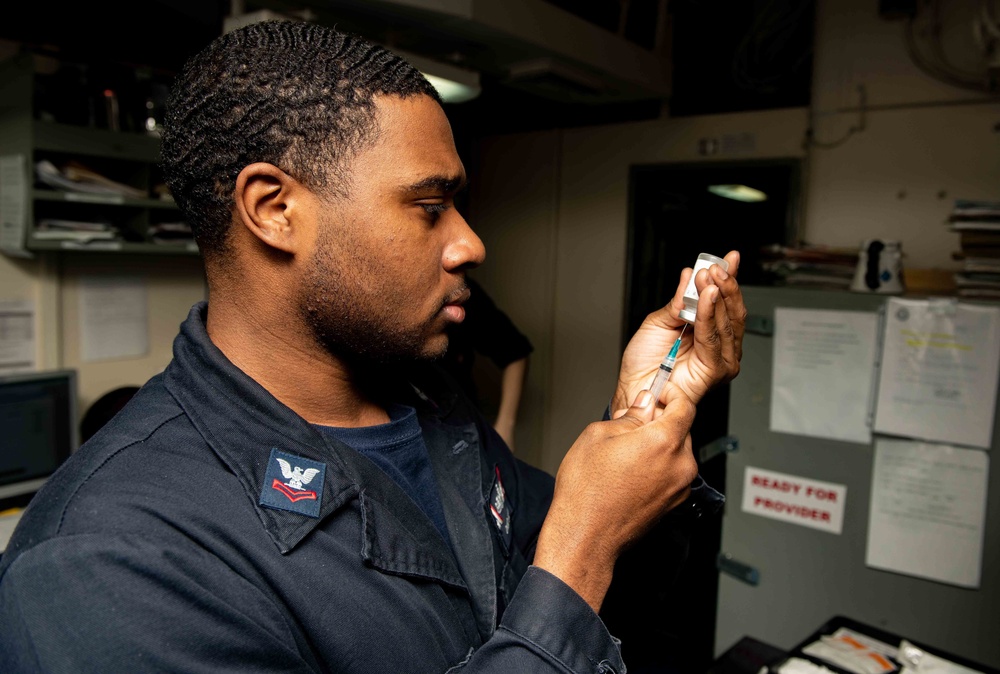 U.S. Sailor prepares a vaccination