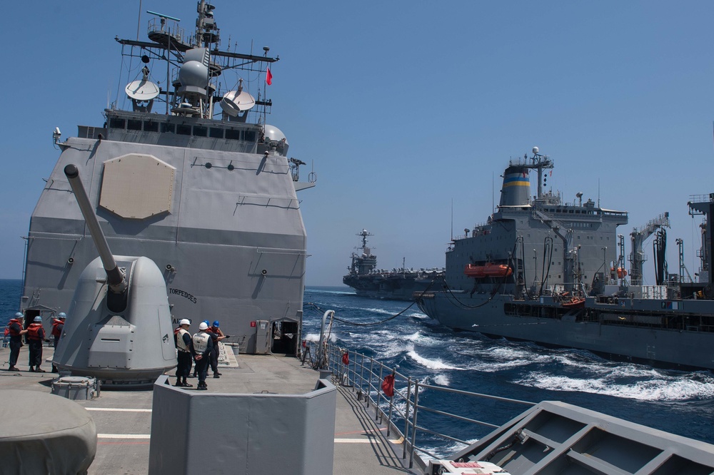 USS Mobile Bay and USS John C. Stennis conduct a replenishment-at-sea with USNS Tippecanoe