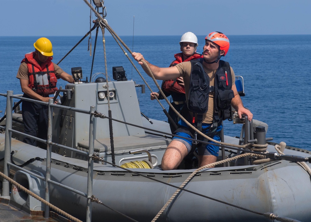 U.S. Sailor prepares for small boat operations aboard the guided-missile cruiser USS Mobile Bay