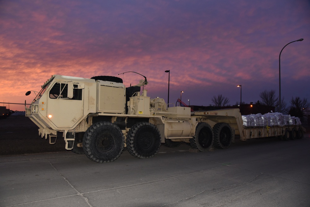 North Dakota Army National Guard Heavy Expanded Mobility Tactical Truck (HEMTT) stands ready and loaded with sandbags