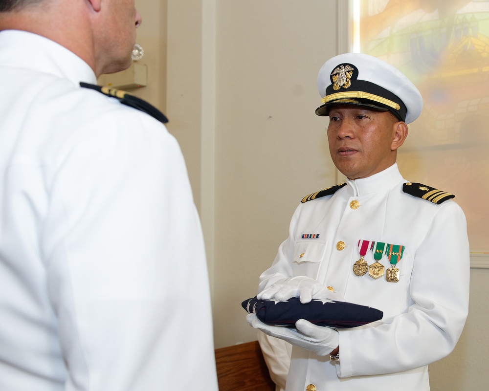 Lt. Cmdr. Felix Villanueva receives his flag