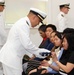 Lt. Cmdr. Felix Villanueva gives the flag to his wife