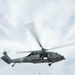 An MH-60S Sea Hawk lowers cargo onto the flight deck of USS Spruance