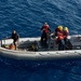 U. S. Sailors operating a Ridged Hull Inflatable Boat (RHIB) prepare to pull alongside