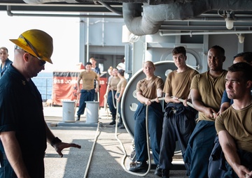 U.S. Sailor directs Sailors on line handling