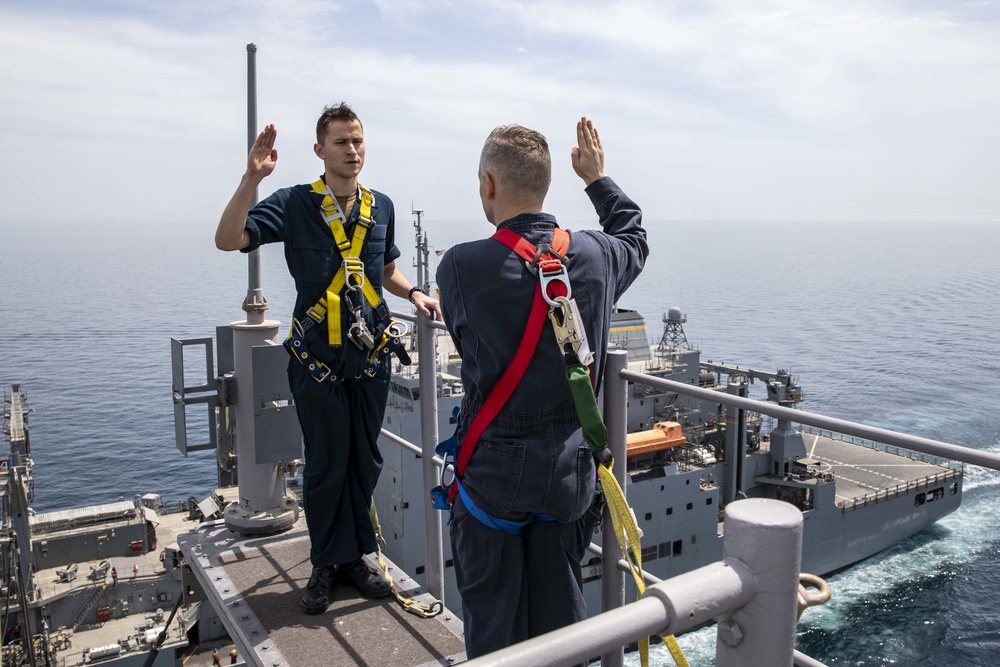 Sailor reenlists on the Aft Mast of the Kearsarge