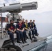 Sailors pose for a group photo on the aft mast of the Kearsarge