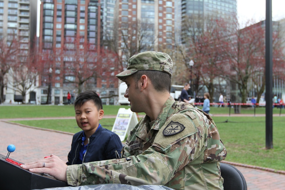 SGT Dignan plays a Binary Game with a child during the Army Expo