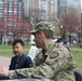 SGT Dignan plays a Binary Game with a child during the Army Expo