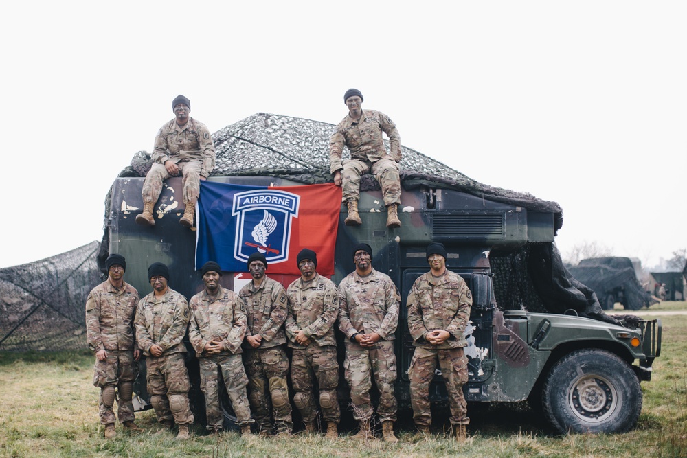 Airborne medics pose as a group next to their truck