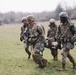 U.S. Army paratroopers litter carry a soldier to a casualty collection point