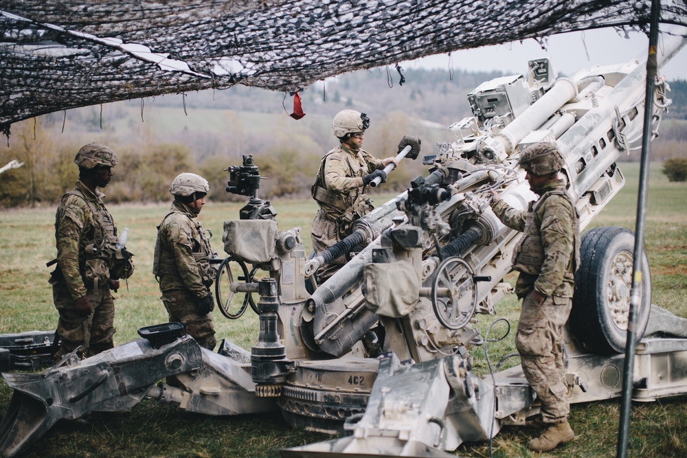 U.S. Army paratroopers prepare their M777