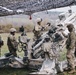 U.S. Army paratroopers prepare their M777