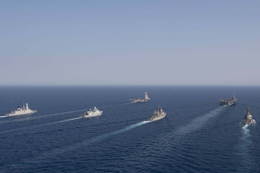 The Charles de Gaulle Carrier Strike Group and the John C. Stennis Carrier Strike Group conduct operations at sea