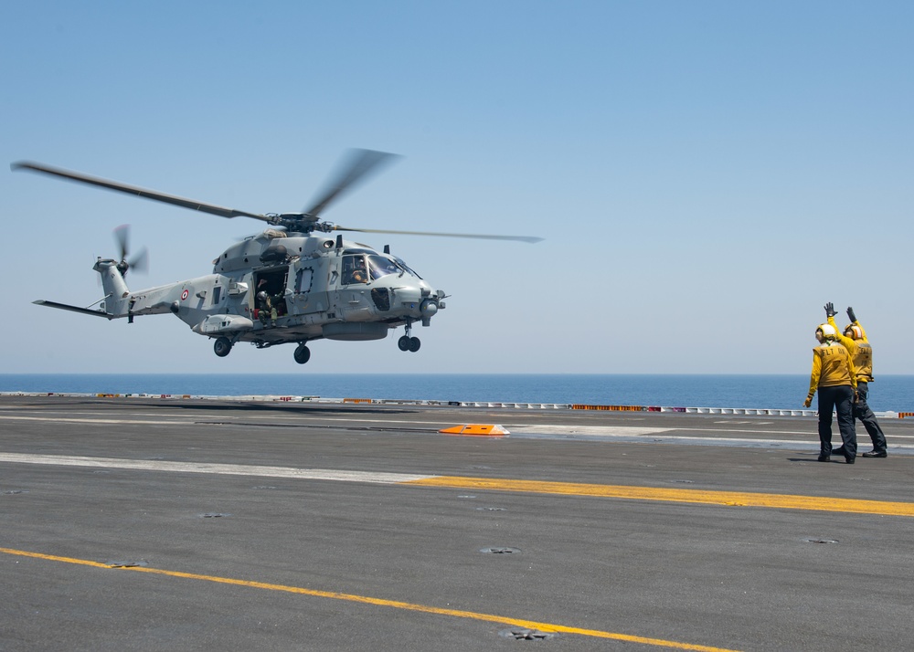 The Charles de Gaulle Carrier Strike Group and the John C. Stennis Carrier Strike Group conduct operations at sea