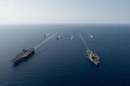 The Charles de Gaulle Carrier Strike Group and the John C. Stennis Carrier Strike Group conduct operations at sea