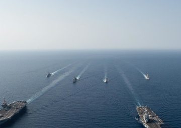 The Charles de Gaulle Carrier Strike Group and the John C. Stennis Carrier Strike Group conduct operations at sea