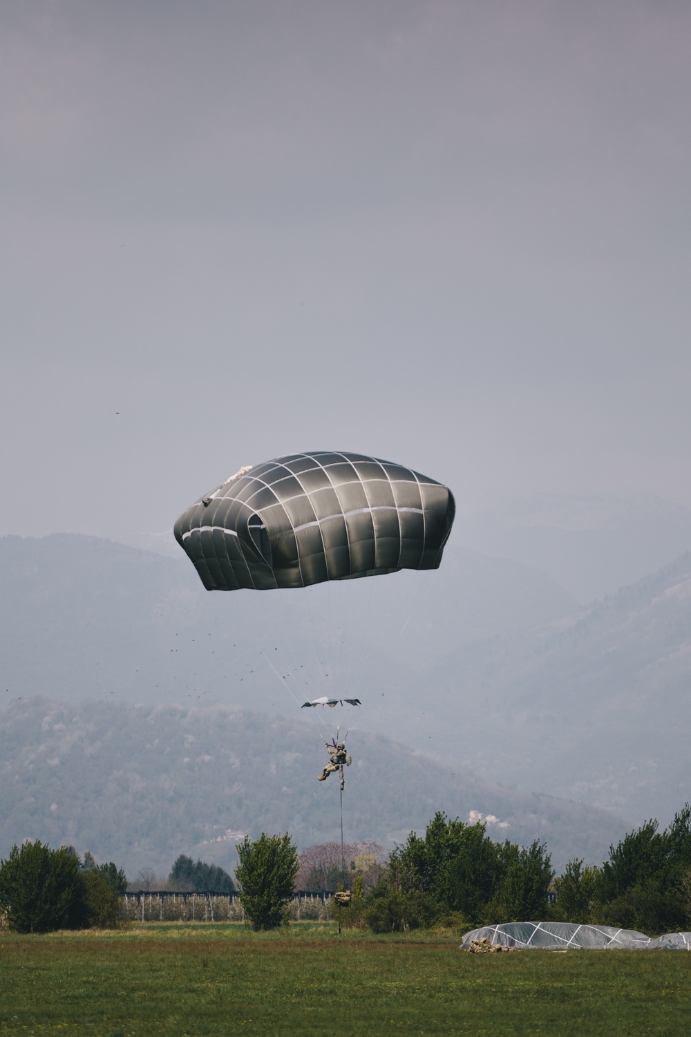 U.S. Army paratrooper descends from the sky