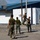 Balikatan 2019: Marines with 3/6 Interact with Philippine Marines A group of military personnel in uniform are playing basketball on an outdoor court near a white building labeled 'Boot Camp PAG-' (partially visible). The players appear to be a mix of U.S. Marines in MARPAT camouflage and what appear to be Filipino soldiers in their own camouflage pattern, suggesting a joint military exercise or friendly game. One player is airborne attempting a shot or rebound near the basket.