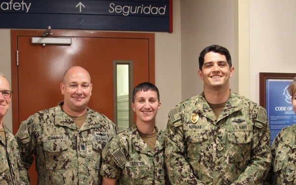 Newly Promoted HM1 Kasey Norman Stands With Command Triad and Career Counselor