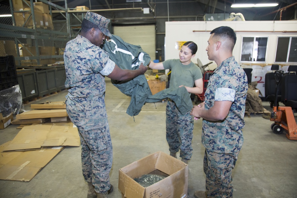 NCOs inspecting coveralls