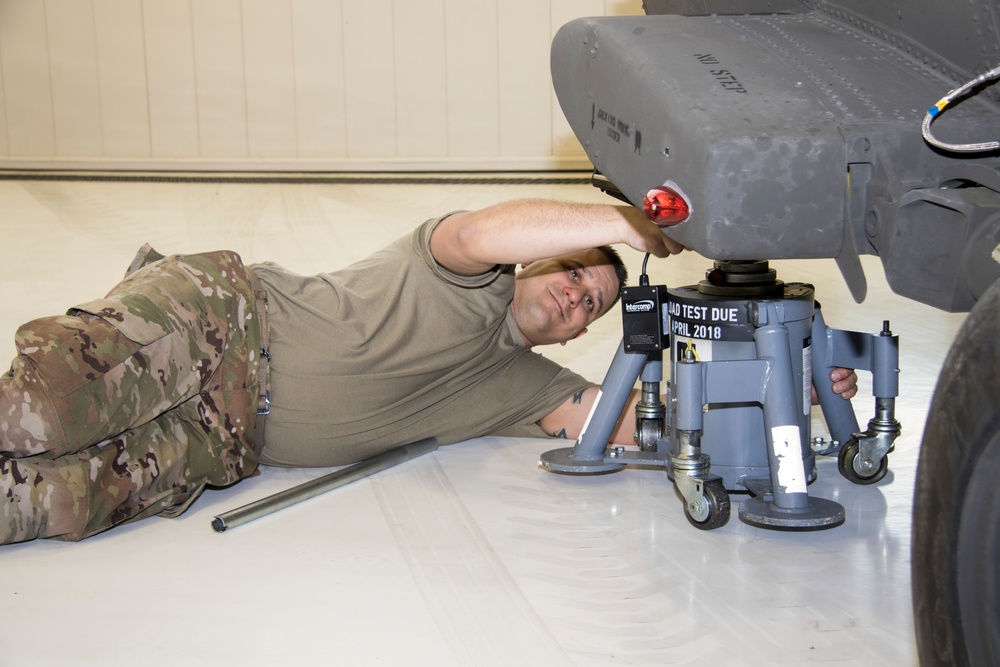 Soldier adjusting jack to weight Black Hawk