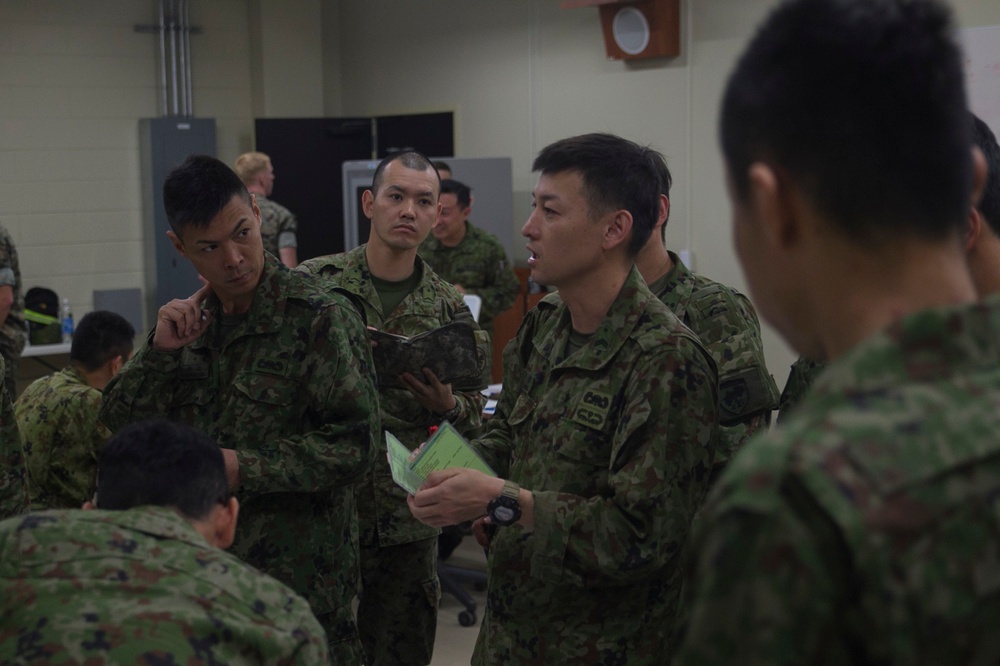 U.S. Marines work with ARDB service members at the Supporting Arms Visual Trainer