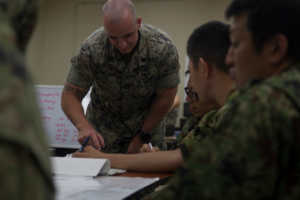 U.S. Marines work with ARDB service members at the Supporting Arms Visual Trainer