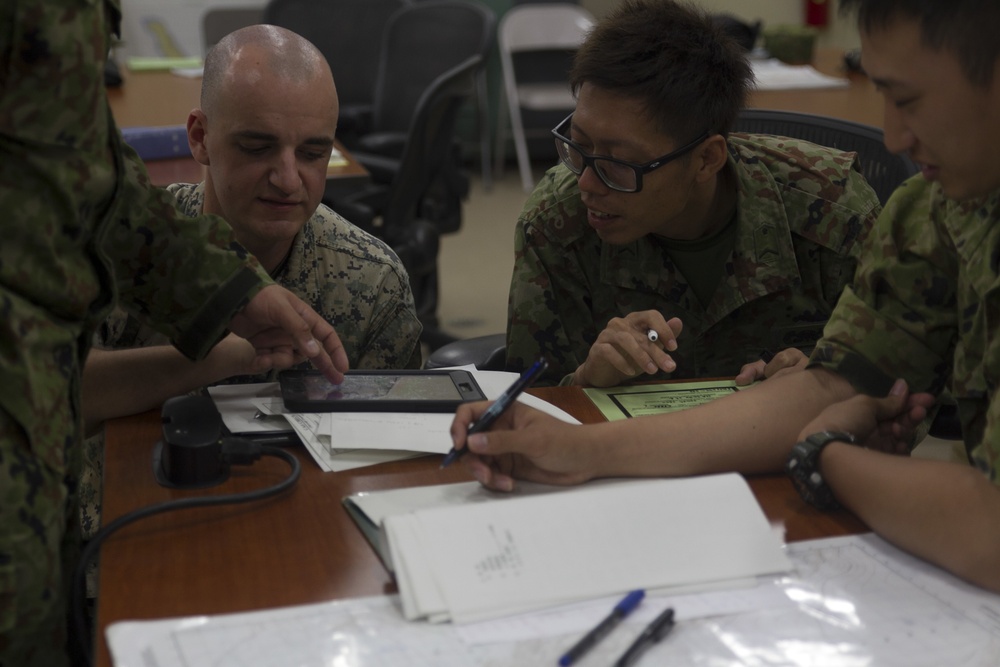 U.S. Marines work with ARDB service members at the Supporting Arms Visual Trainer