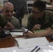 U.S. Marines work with ARDB service members at the Supporting Arms Visual Trainer