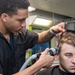 U.S. Sailor gives a haircut