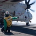 U.S. Sailor signals to launch an aircraft