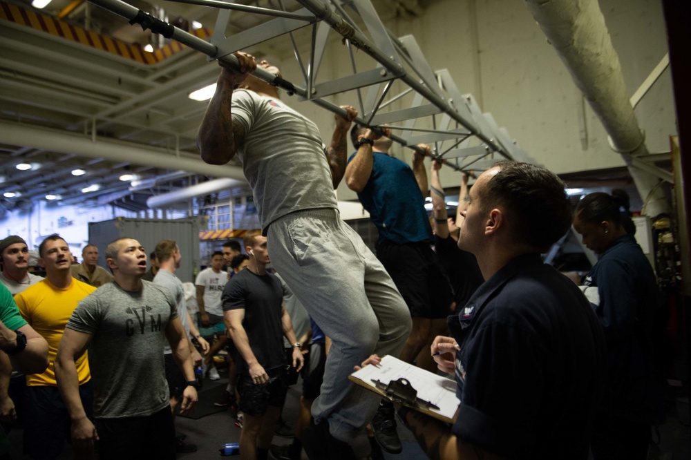 U.S. Sailors participate in a pull-up contest for a Sexual Assault Awareness and Prevention Month