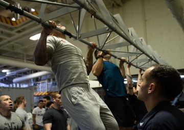 U.S. Sailors participate in a pull-up contest for a Sexual Assault Awareness and Prevention Month