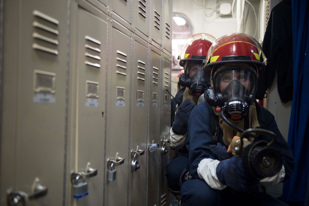 U.S. Sailors Engage a Simulated Fire during a GQ Drill aboard USS Spruance
