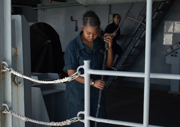 U.S. Sailor sweeps on the fantail