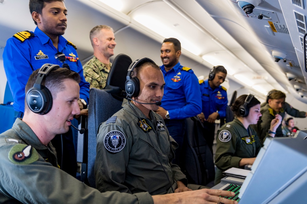 Sri Lanka military members, Commander of Navy Expeditionary Forces Command Pacific fly in a P-8 during CARAT 19
