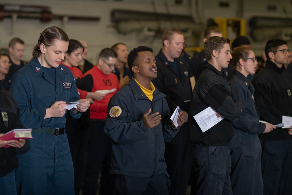 U.S. Sailors attend an Easter sunrise service aboard the aircraft carrier USS John C. Stennis (CVN 74)