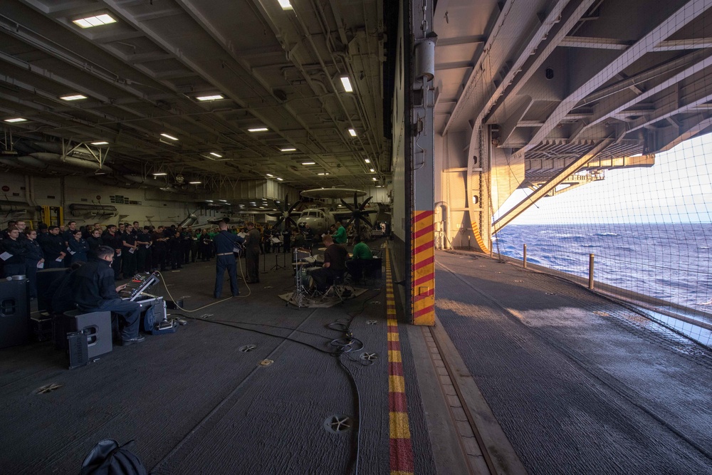 U.S. Sailors attend an Easter sunrise service aboard the aircraft carrier USS John C. Stennis (CVN 74)