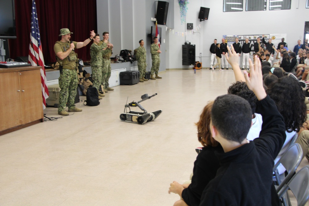 Members from Explosive Ordnance Disposal Group 2 engage with students from Antilles Middle School on Fort Buchanan as a part of Navy Week Puerto Rico.