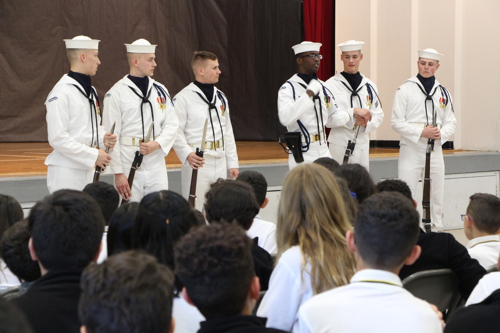 Members of the U.S. Navy Drill Team engage with students from Antilles Middle School on Fort Buchanan as a part of Navy Week Puerto Rico.