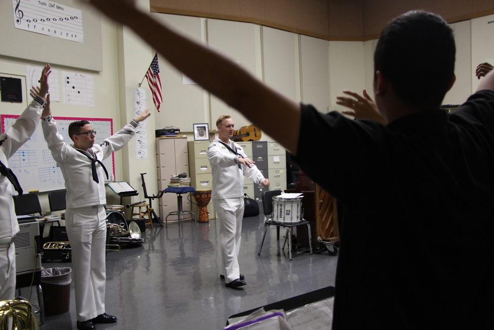 Members of the Navy Band Southeast Brass Quintet instruct students from Antilles High School on Fort Buchanan as a part of Navy Week Puerto Rico.