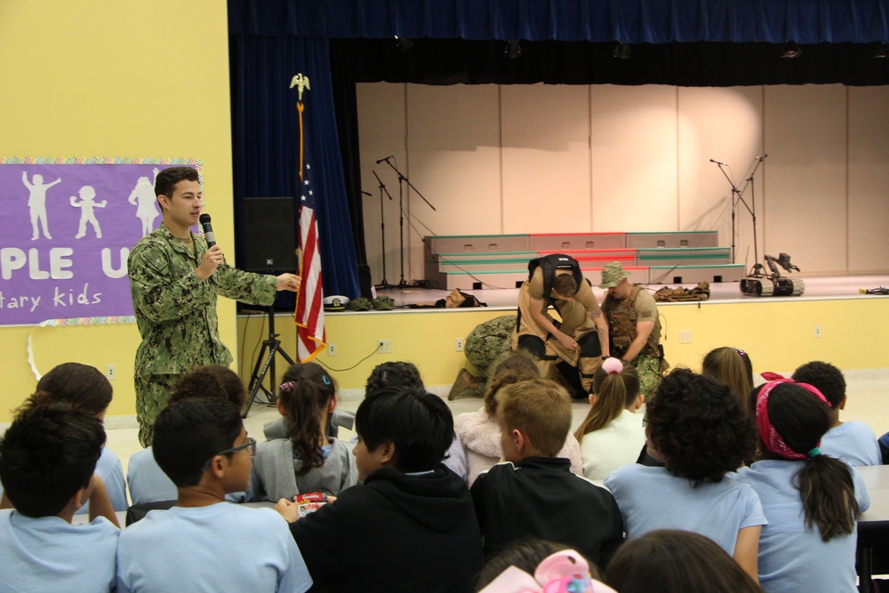 Lieutenant Junior Grade Tim Loret from Explosive Ordnance Group 2 answers questions from students from Antilles Middle School on Fort Buchanan as a part of Navy Week Puerto Rico.