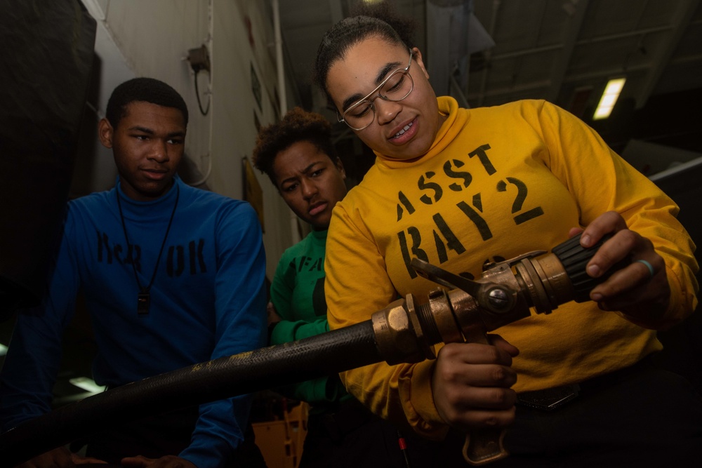 U.S. Sailors receive training on a vari-nozzle