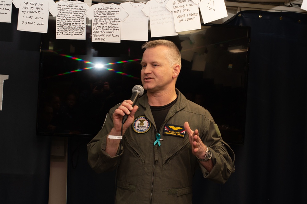 U.S. Sailors participate in a candlelight vigil during Sexual Assault Awareness and Prevention Month