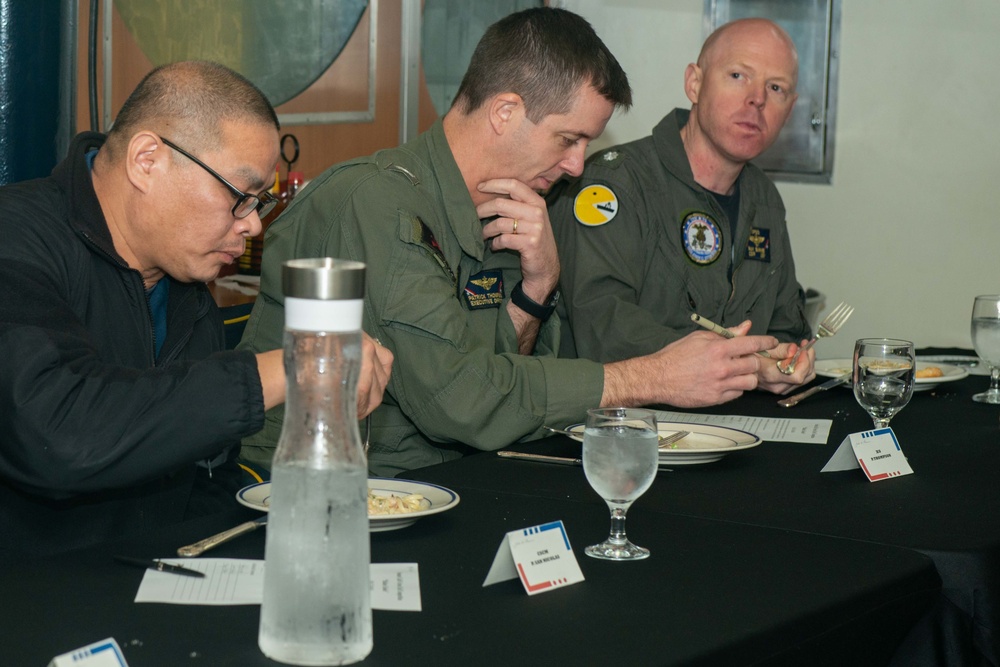 Executive officer judges a cooking competition