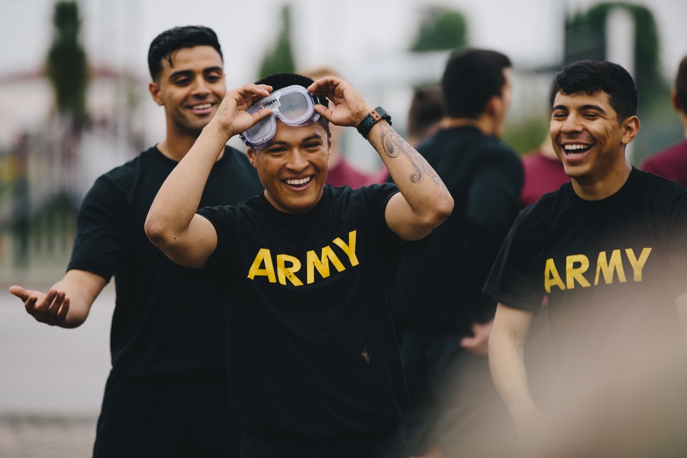 Sky Soldiers attempt cornhole while wearing vision impairment goggles