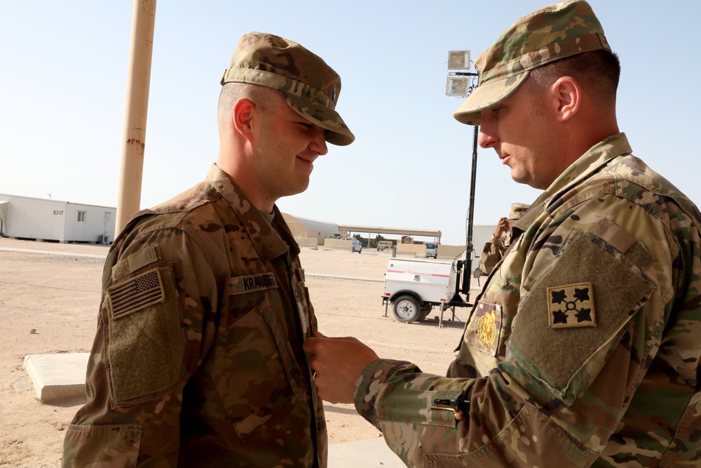 Father Pins Son to Specialist During Deployment in Kuwait