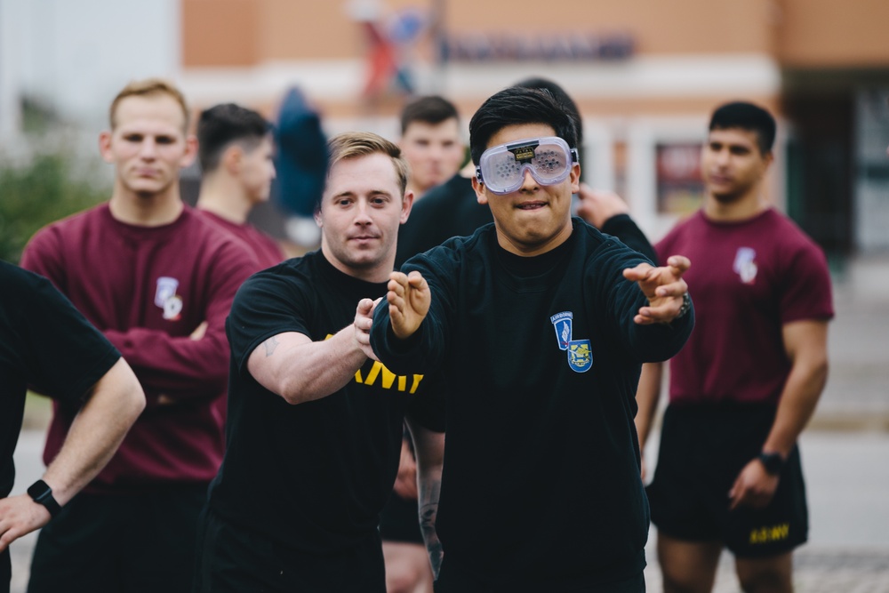 Sky Soldier attempts cornhole while wearing vision impairment goggles