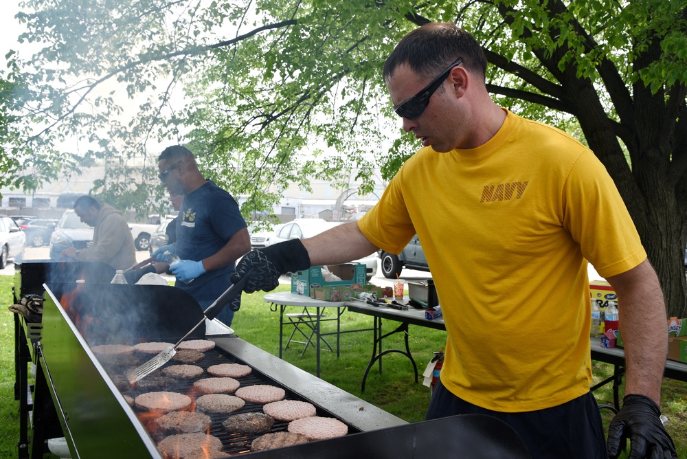 Sailor cooks during base event